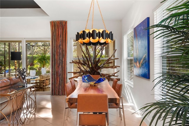 tiled dining room featuring a chandelier