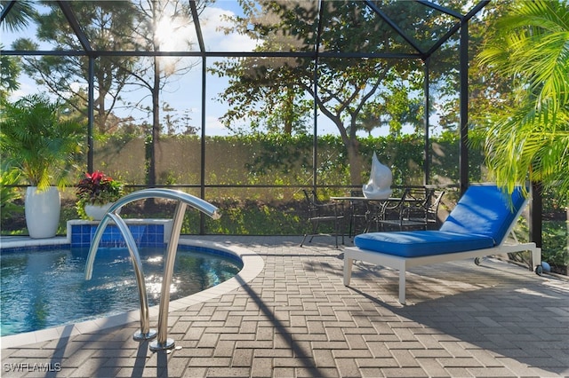 view of pool featuring a lanai and a patio area