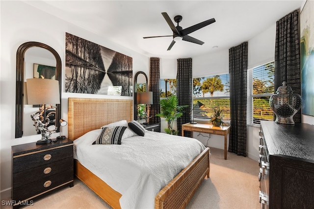 bedroom featuring ceiling fan and light carpet