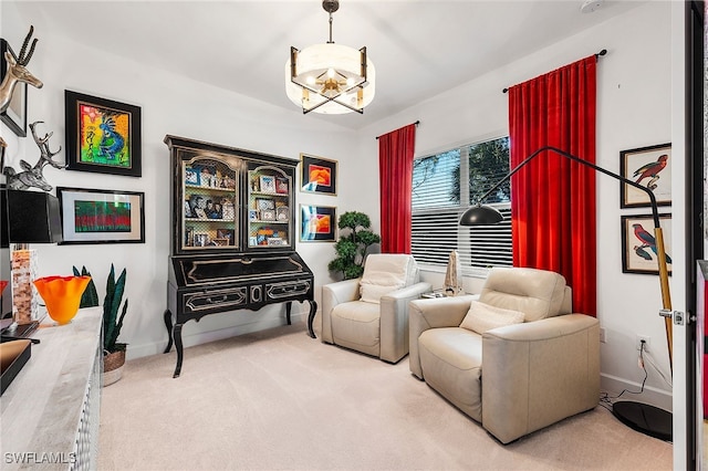 living area with an inviting chandelier and carpet flooring