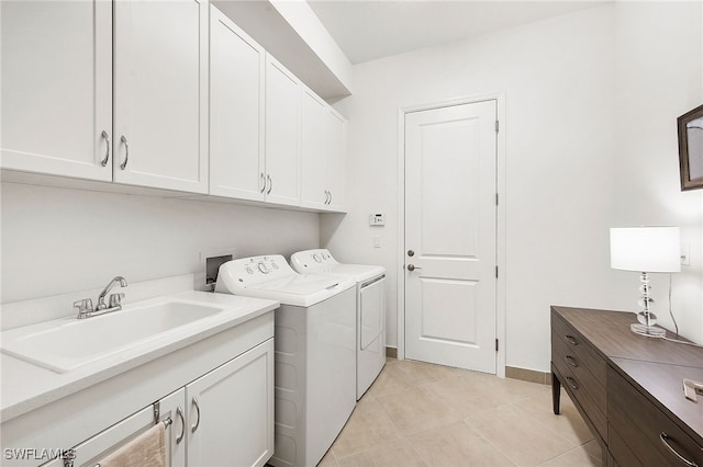 laundry area featuring cabinets, separate washer and dryer, sink, and light tile patterned floors