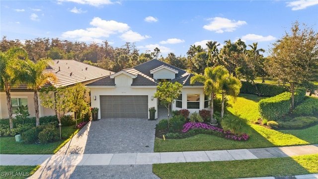 view of front of home featuring a garage and a front yard