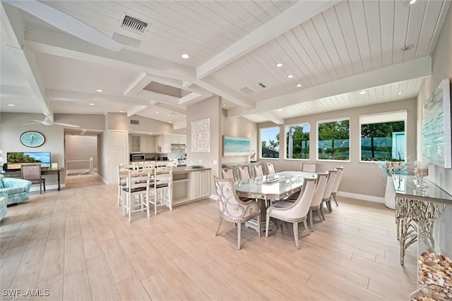 dining space with vaulted ceiling with beams, light wood-type flooring, and ceiling fan