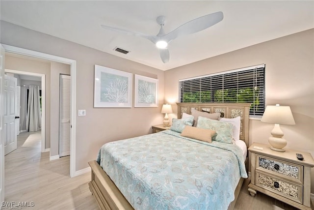 bedroom with light hardwood / wood-style flooring and ceiling fan