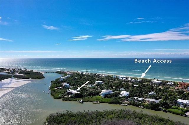 drone / aerial view featuring a water view and a view of the beach