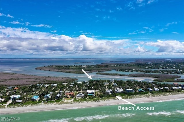 birds eye view of property featuring a water view and a view of the beach