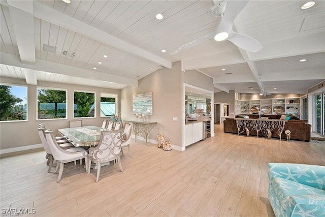 dining space featuring lofted ceiling with beams, light hardwood / wood-style floors, and ceiling fan