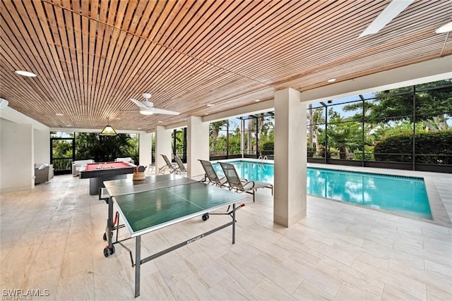 view of swimming pool with a patio, a hot tub, ceiling fan, and a lanai