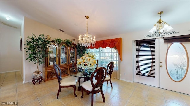 dining room featuring light tile patterned floors, lofted ceiling, and a notable chandelier