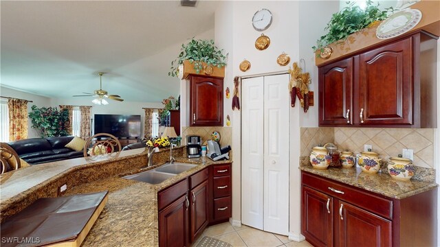 2718 SW 37th St, Cape Coral, FL 33914 - kitchen featuring reddish brown cabinets, ceiling fan, backsplash, open floor plan, and light tile patterned floors