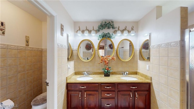 2718 SW 37th St, Cape Coral, FL 33914 - full bath with tile walls, double vanity, and wainscoting