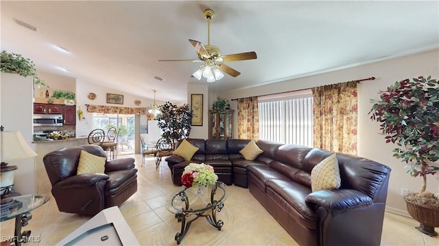 living room featuring ceiling fan, light tile patterned flooring, and lofted ceiling