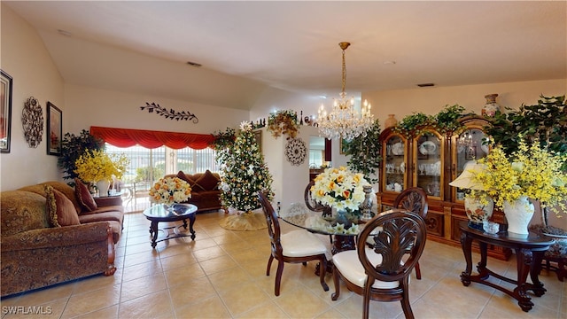 dining area with light tile patterned floors and a notable chandelier