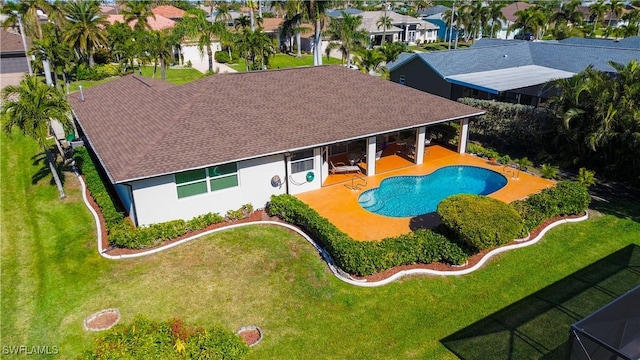 view of swimming pool featuring a yard and a patio