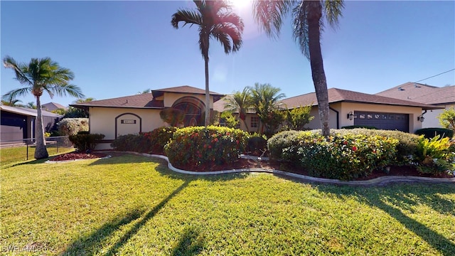 view of front of home with a garage and a front lawn