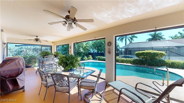 2718 SW 37th St, Cape Coral, FL 33914 - swimming pool featuring a ceiling fan, a patio, outdoor dining area, and glass enclosure