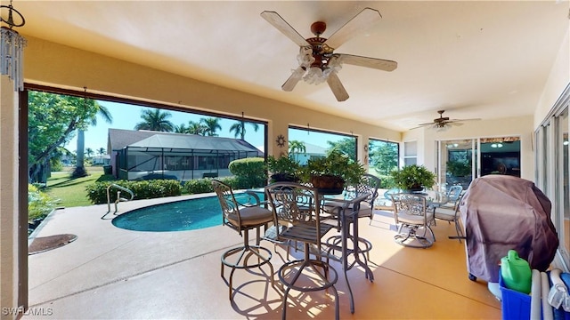 2718 SW 37th St, Cape Coral, FL 33914 - swimming pool featuring outdoor dining space, a patio, glass enclosure, a ceiling fan, and area for grilling