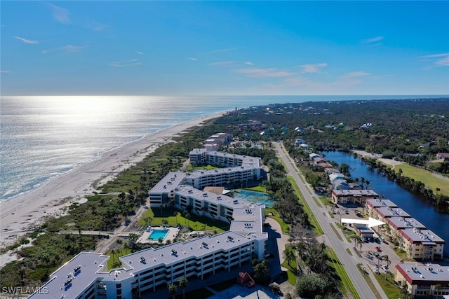 drone / aerial view with a water view and a beach view