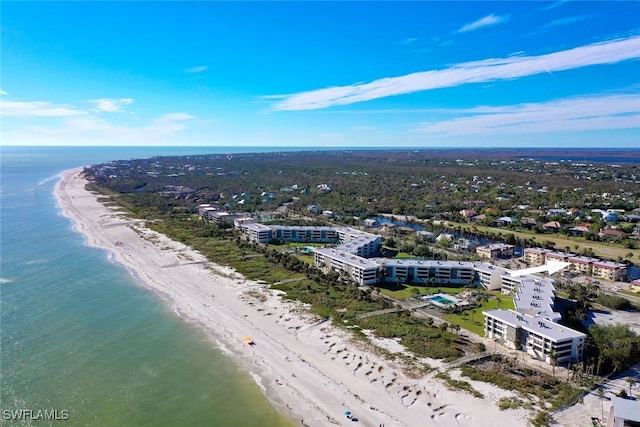 birds eye view of property with a water view and a beach view