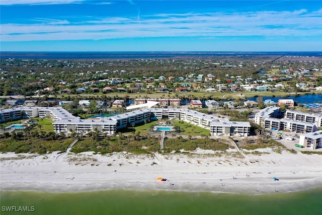 aerial view with a water view and a beach view