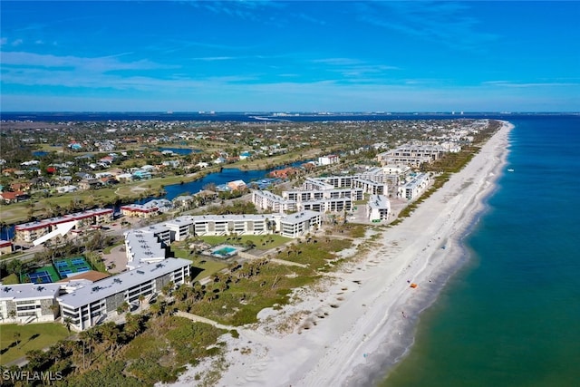 aerial view with a water view and a beach view