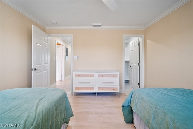 bedroom with light hardwood / wood-style floors and ornamental molding