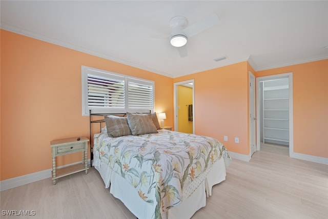 bedroom with ceiling fan, light hardwood / wood-style flooring, and crown molding