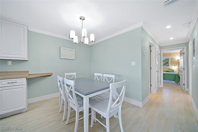 dining area with light hardwood / wood-style floors, crown molding, and a chandelier