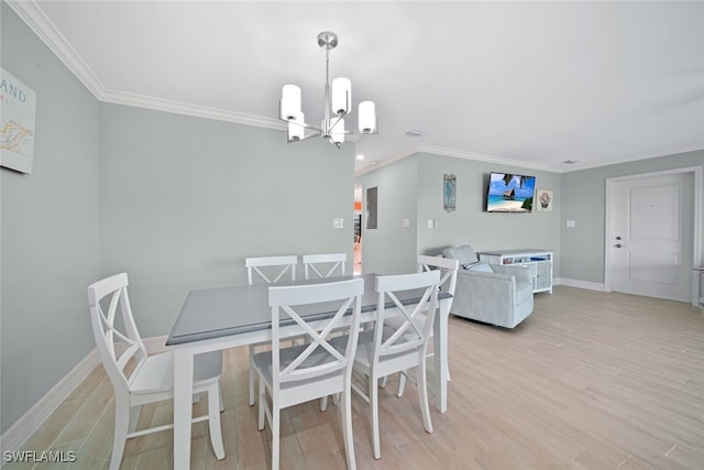 dining space featuring a chandelier, light hardwood / wood-style floors, and ornamental molding