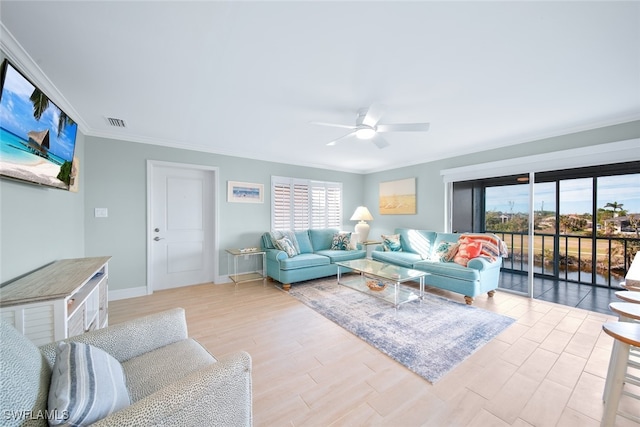 living room featuring ceiling fan, plenty of natural light, ornamental molding, and light wood-type flooring