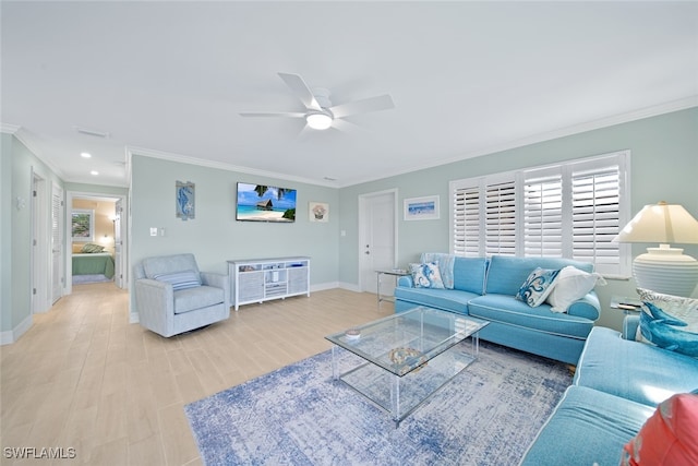 living room with light hardwood / wood-style floors, ceiling fan, and ornamental molding