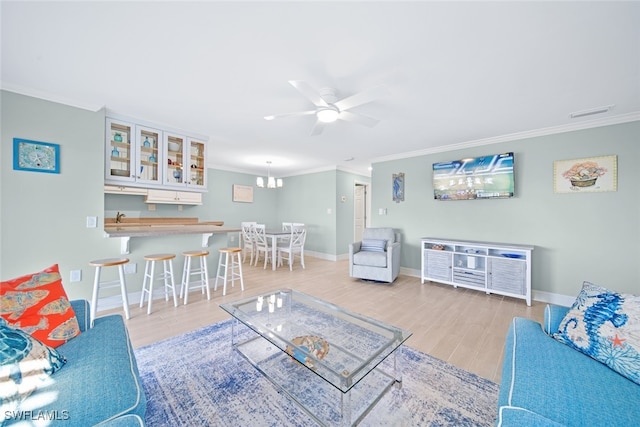 living room featuring ceiling fan with notable chandelier, light hardwood / wood-style floors, and crown molding