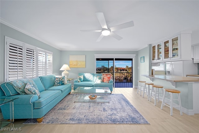 living room featuring crown molding, ceiling fan, and light hardwood / wood-style floors