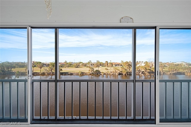 unfurnished sunroom with a water view