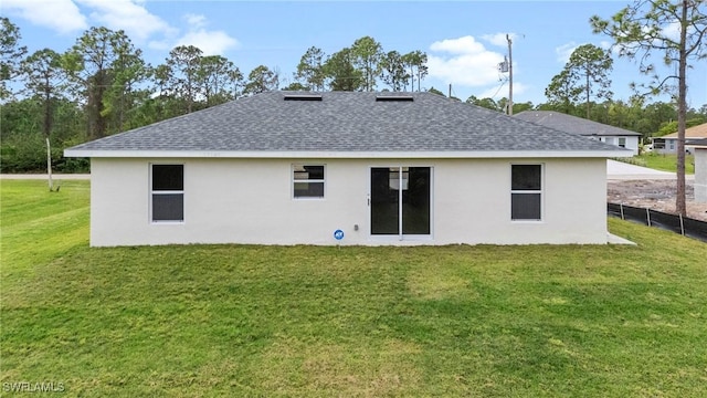 rear view of property with a yard