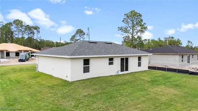 back of property featuring a lawn