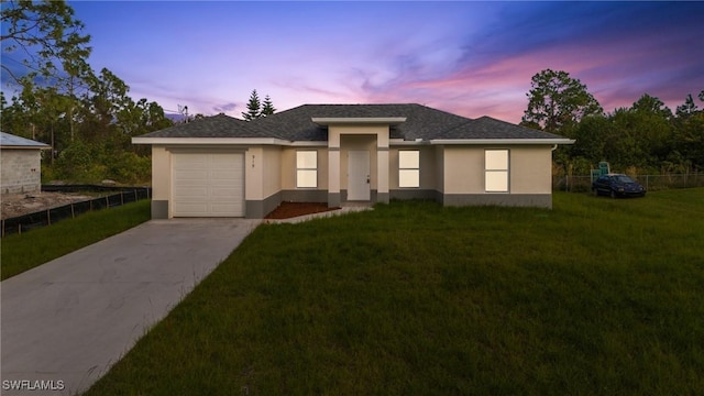 view of front facade featuring a yard and a garage