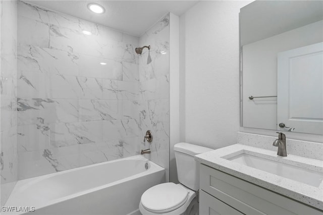 full bathroom with toilet, vanity, and tiled shower / bath combo