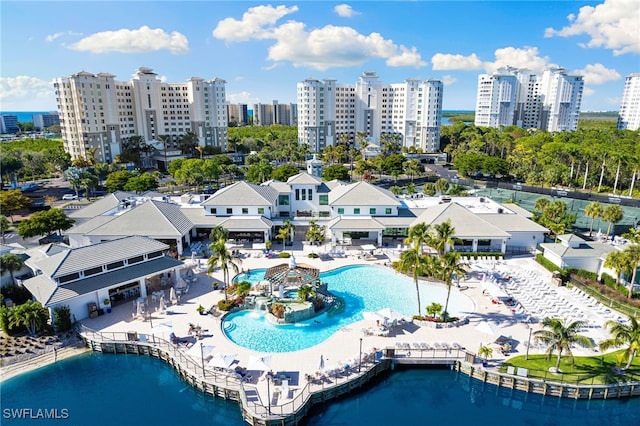 birds eye view of property with a water view and a city view