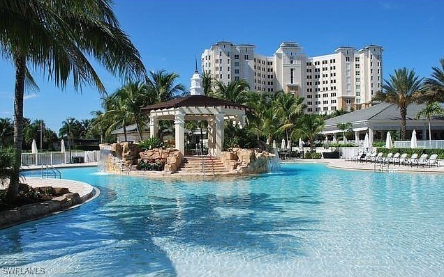 pool featuring a patio, fence, and a pergola