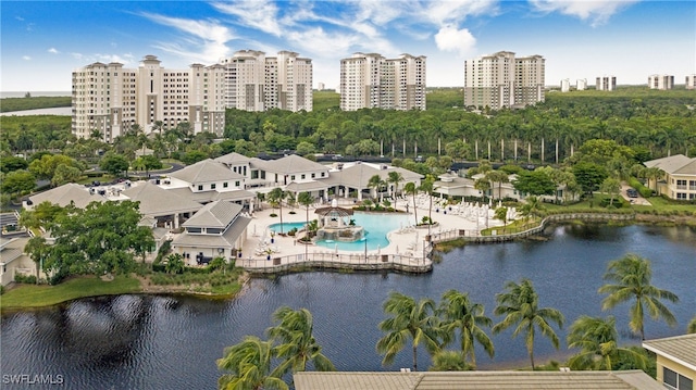 birds eye view of property featuring a city view and a water view