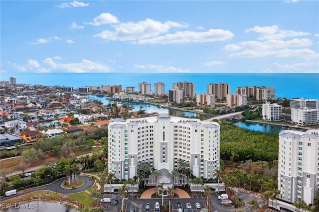 birds eye view of property featuring a view of city and a water view