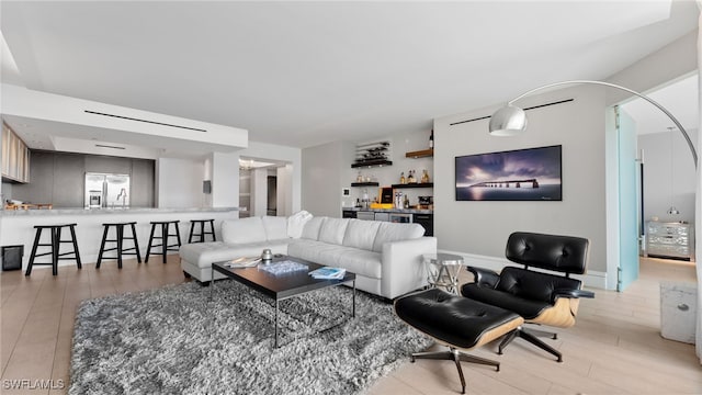 living room featuring light hardwood / wood-style flooring and indoor bar