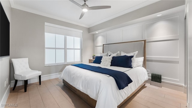 bedroom featuring light hardwood / wood-style flooring, ceiling fan, and ornamental molding