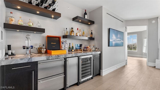 bar with light wood-type flooring and wine cooler