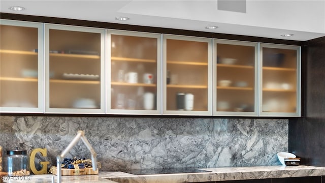 interior details featuring tasteful backsplash, recessed lighting, and black electric cooktop