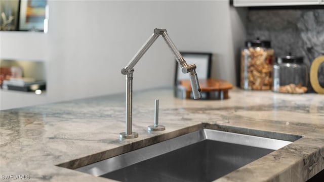 details with a sink and stone countertops