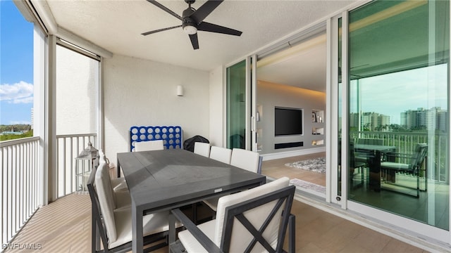 sunroom / solarium featuring ceiling fan