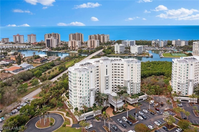 drone / aerial view featuring a water view and a city view