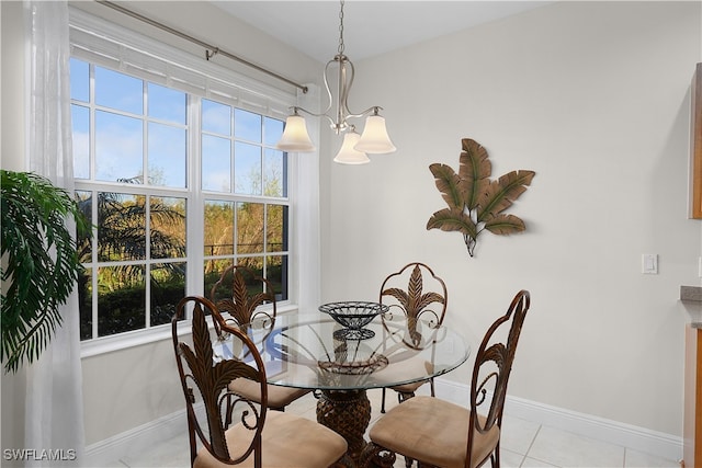 dining space featuring light tile patterned floors, a healthy amount of sunlight, and a notable chandelier